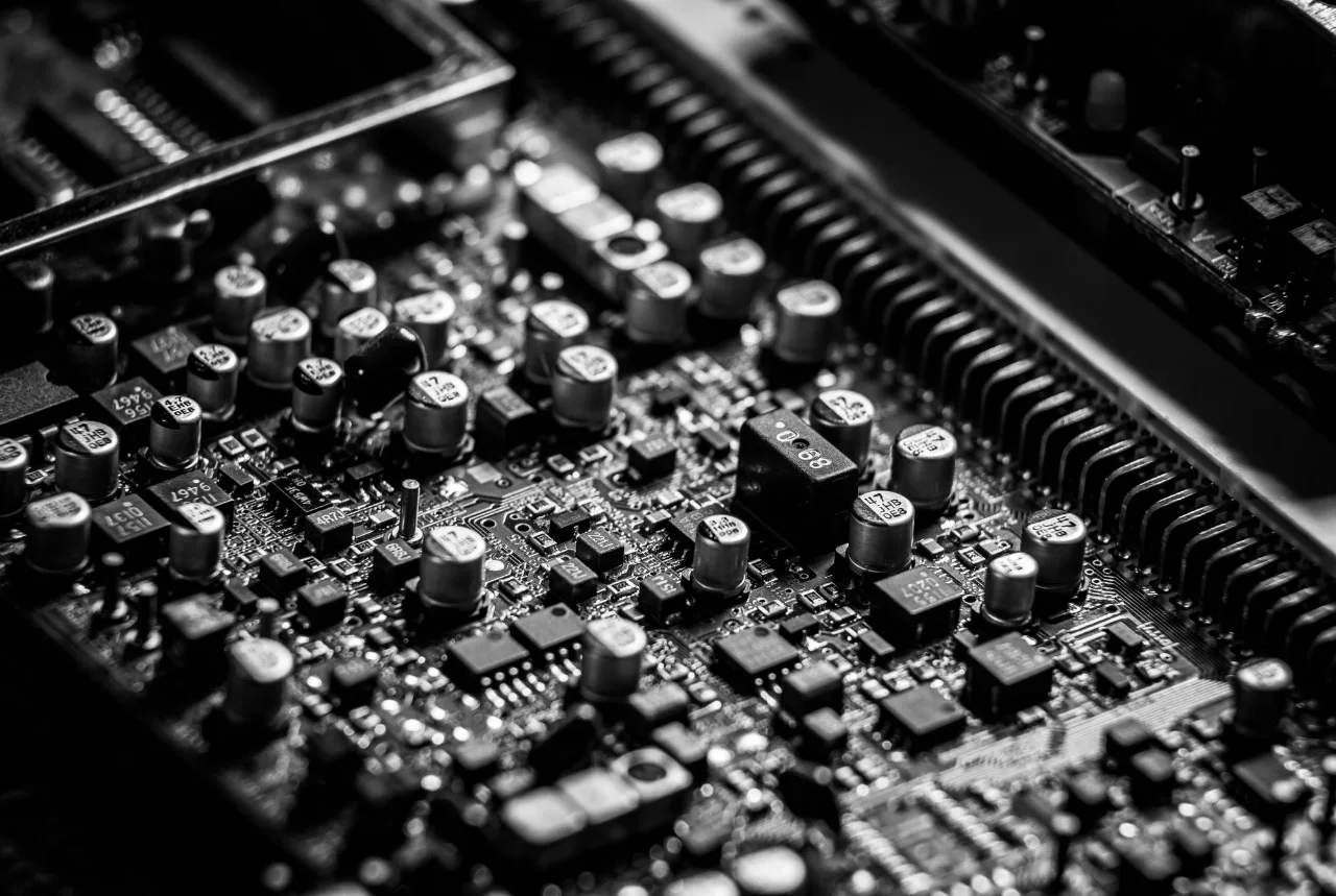Black and white close-up of components on an electronic circuit board