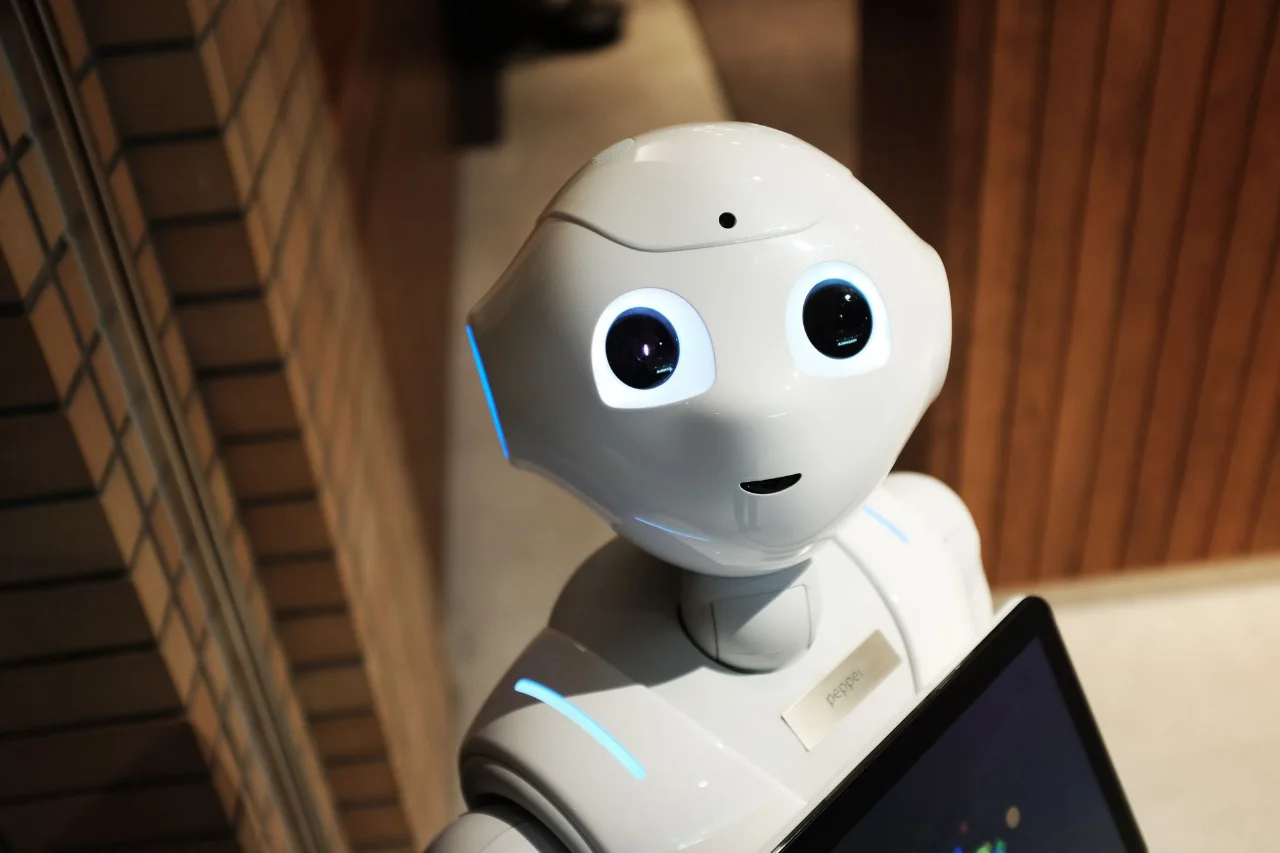 Pepper humanoid robot looking up at the camera indoors