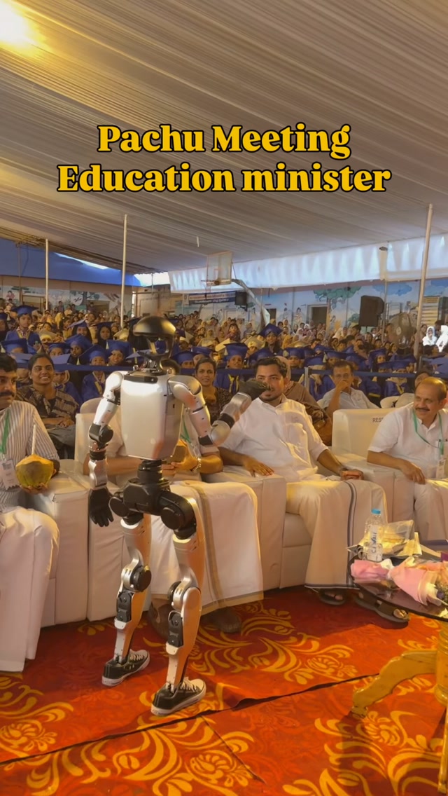 Pachu greeting people seated at an education event