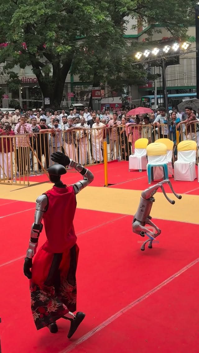Pachu and a robot dog performing on a red carpet in front of a crowd